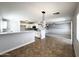 Open concept living room and kitchen with tile flooring and natural light at 37061 W Bello Ln, Maricopa, AZ 85138
