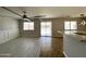 Cozy living room boasts ceiling fan, backyard views, and adjoins the dining area at 37061 W Bello Ln, Maricopa, AZ 85138