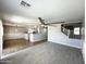 Bright living room has a ceiling fan and overlooks the kitchen and staircase at 37061 W Bello Ln, Maricopa, AZ 85138