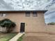 Charming two-story townhouse with stucco exterior, front door, and green shrubbery in the front yard at 4231 N 69Th Dr # 1297, Phoenix, AZ 85033