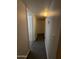 A view of a well-lit hallway with multiple doors and neutral paint at 4231 N 69Th Dr # 1297, Phoenix, AZ 85033
