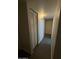This hallway has a closet with louvered doors and neutral paint at 4231 N 69Th Dr # 1297, Phoenix, AZ 85033
