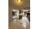 View from a living area looking into the kitchen with dated cabinetry and white appliances at 4231 N 69Th Dr # 1297, Phoenix, AZ 85033
