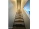 Carpeted stairway leading to the upper level of this home at 4231 N 69Th Dr # 1297, Phoenix, AZ 85033