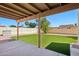 Backyard featuring a covered patio, green grass, and gravel at 4231 W Villa Maria Dr, Glendale, AZ 85308