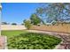 Wide shot of a backyard featuring artificial grass, a block wall, and rock at 4231 W Villa Maria Dr, Glendale, AZ 85308