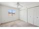 Sunlit bedroom features a window and closet with folding doors at 4231 W Villa Maria Dr, Glendale, AZ 85308