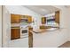 A charming kitchen features ample wood cabinets, a breakfast bar, and white appliances at 4231 W Villa Maria Dr, Glendale, AZ 85308
