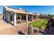 Desert backyard featuring a covered patio, putting green, and low-maintenance landscaping for outdoor enjoyment at 4304 N Ranier --, Mesa, AZ 85215
