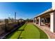 Well-manicured backyard with putting green, flowering plants and covered patio, perfect for entertaining or relaxing at 4304 N Ranier --, Mesa, AZ 85215