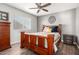 Cozy bedroom with wood-look floors, ceiling fan and a picture window at 4304 N Ranier --, Mesa, AZ 85215