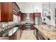 Gourmet kitchen featuring stainless steel appliances, dark wood cabinets, and granite countertops at 4304 N Ranier --, Mesa, AZ 85215