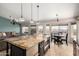 Open concept kitchen boasting a large island with granite countertops and an adjacent dining area at 4304 N Ranier --, Mesa, AZ 85215