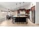 Eat-in kitchen with dark wood cabinetry, a stainless steel fridge, and a central island with bar seating at 4304 N Ranier --, Mesa, AZ 85215
