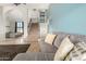 Inviting living room with tile flooring, staircase, and a comfortable gray couch at 4304 N Ranier --, Mesa, AZ 85215