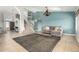 Inviting living room with tile flooring, staircase, chandelier, and a comfortable gray couch at 4304 N Ranier --, Mesa, AZ 85215