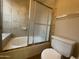 Bathroom featuring a tub and shower combo with tiled walls and a convenient grab bar at 4332 E Frye Rd, Phoenix, AZ 85048