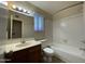 Bright bathroom featuring a single sink vanity, tiled shower-tub, and neutral color palette at 4332 E Frye Rd, Phoenix, AZ 85048