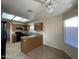 Bright kitchen with granite counters, wooden cabinets, a ceiling fan, and natural lighting at 4332 E Frye Rd, Phoenix, AZ 85048