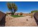Large backyard surrounded by a block wall and low maintenance gravel and artificial turf at 43949 W Sagebrush Trl, Maricopa, AZ 85138