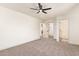 Large bedroom features carpeted floors, a ceiling fan, and easy access to the bathroom at 43949 W Sagebrush Trl, Maricopa, AZ 85138