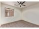 Well-lit bedroom with a window, neutral paint, plush gray carpet, and modern ceiling fan at 43949 W Sagebrush Trl, Maricopa, AZ 85138