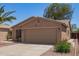Welcoming single-story home with desert landscaping, a two-car garage, and mature bushes at 43949 W Sagebrush Trl, Maricopa, AZ 85138