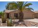 Inviting home with desert landscaping, a two-car garage, and a vibrant cactus in the front yard at 43949 W Sagebrush Trl, Maricopa, AZ 85138