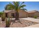 Attractive home featuring desert landscaping, a two-car garage, and mature cactus at 43949 W Sagebrush Trl, Maricopa, AZ 85138