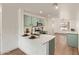 Bright kitchen features stainless appliances, stone countertops, and ample storage space at 43949 W Sagebrush Trl, Maricopa, AZ 85138