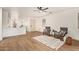 Bright living room features a ceiling fan, hardwood floors, and modern furnishings at 43949 W Sagebrush Trl, Maricopa, AZ 85138