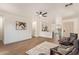 Bright living room features hardwood floors, a ceiling fan, an open layout, and modern decor at 43949 W Sagebrush Trl, Maricopa, AZ 85138