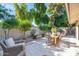 Lush backyard with brick walls, mature trees, outdoor seating, and a charming water fountain feature at 4525 N 66Th St # 10, Scottsdale, AZ 85251