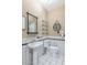 Bathroom featuring a pedestal sink, a wall mirror, floating shelves, and a toilet in a tiled space at 4525 N 66Th St # 10, Scottsdale, AZ 85251
