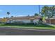 Charming single-story home with well-maintained landscaping and a tile roof under a beautiful blue sky at 4525 N 66Th St # 10, Scottsdale, AZ 85251
