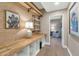Hallway with decorative wooden shelves, hardwood floors, a painting, and an adjacent room at 4525 N 66Th St # 10, Scottsdale, AZ 85251