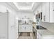 Bright kitchen features white cabinets, modern appliances, stainless steel microwave, and gray countertops at 4525 N 66Th St # 10, Scottsdale, AZ 85251