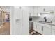White kitchen features updated appliances and cabinets with modern hardware and backsplash at 4525 N 66Th St # 10, Scottsdale, AZ 85251