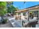 Cozy outdoor patio featuring comfortable wicker furniture, a dining table, and a well-maintained yard at 4525 N 66Th St # 10, Scottsdale, AZ 85251
