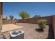 The backyard has a wall and desert landscaping at 4605 W Beverly Rd, Laveen, AZ 85339