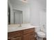 Bathroom showcasing a wood vanity, large mirror, toilet, and tub with shower at 4605 W Beverly Rd, Laveen, AZ 85339