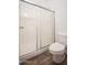 Bathroom featuring an enclosed shower with glass doors and a toilet at 4605 W Beverly Rd, Laveen, AZ 85339