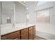 Bright bathroom with double sinks, wood cabinets and a soaking tub at 4605 W Beverly Rd, Laveen, AZ 85339