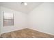 Bedroom featuring wood-look floors and a window allowing for natural light at 4605 W Beverly Rd, Laveen, AZ 85339