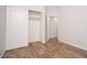 Bedroom with sliding door closet featuring wood-look flooring at 4605 W Beverly Rd, Laveen, AZ 85339