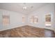 Bright bedroom featuring wood-look tile flooring, neutral walls, and multiple windows at 4605 W Beverly Rd, Laveen, AZ 85339
