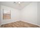 Bedroom with wood-look flooring, a ceiling fan and natural light at 4605 W Beverly Rd, Laveen, AZ 85339