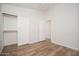 This bedroom features wood-look tile flooring, a ceiling fan, and a closet with shelving and sliding doors at 4605 W Beverly Rd, Laveen, AZ 85339