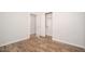 Bedroom showcasing wood-look floors, closet and access to other rooms at 4605 W Beverly Rd, Laveen, AZ 85339