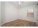 Bedroom featuring wood-look floors, a ceiling fan and natural light at 4605 W Beverly Rd, Laveen, AZ 85339